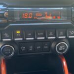 Auto-Klimaanlagensteuerung mit Bedienelementen für Temperatur, Belüftung, und 12-V-Steckdose sowie USB-Anschluss.